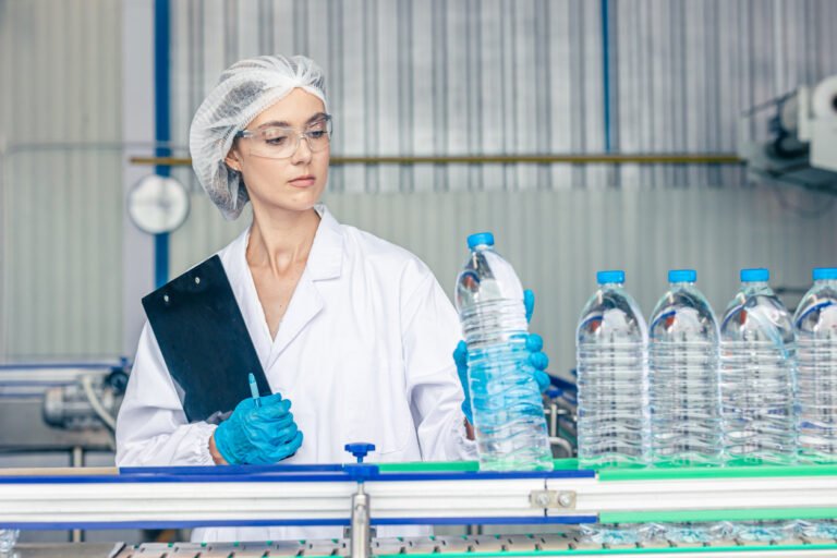 worker in drinking water factory. women workers caucasian labor in beverage clean production conveyor belt mineral water manufactory.